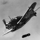 Dive flaps extended, a US Navy SBD Dauntless dives on its target and releases its bomb (US Navy)